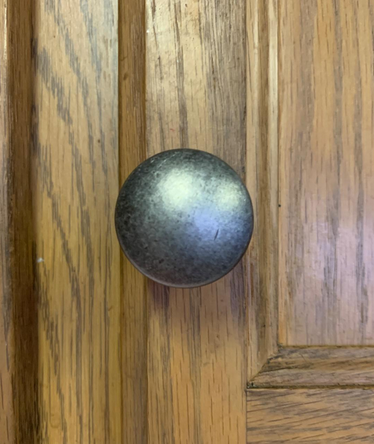 wood kitchen cabinet door with a weathered nickel round knob by Cosmas5305WN