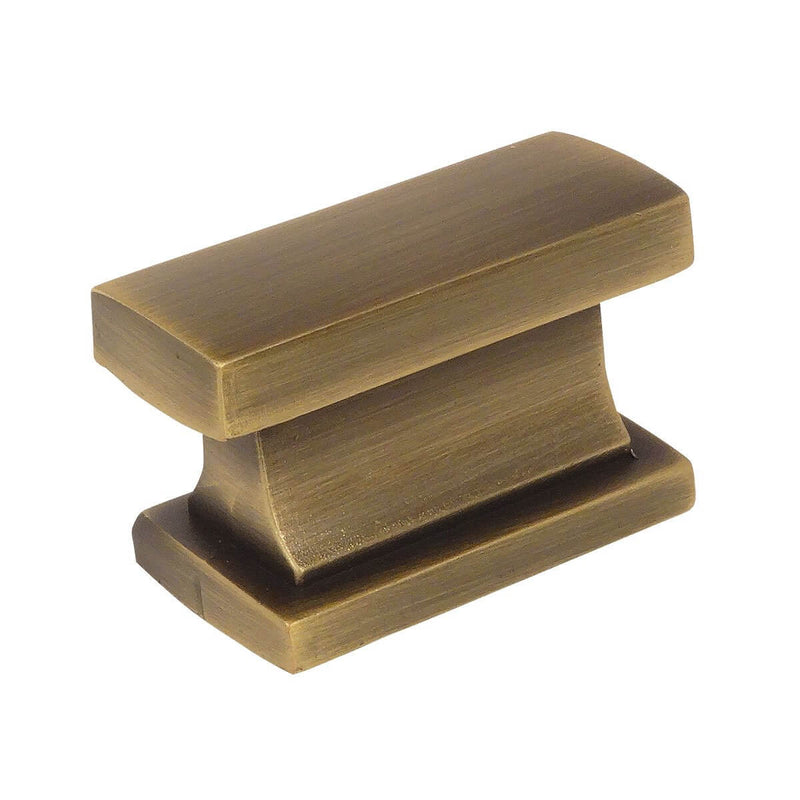 Rectangular contemporary cabinet knob in brushed antique brass finish with one and seven sixteenths inch width