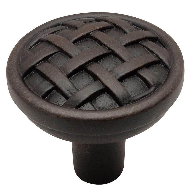 Cabinet drawer knob in oil rubbed bronze finish with woven lines design and one and three eighths inch diameter