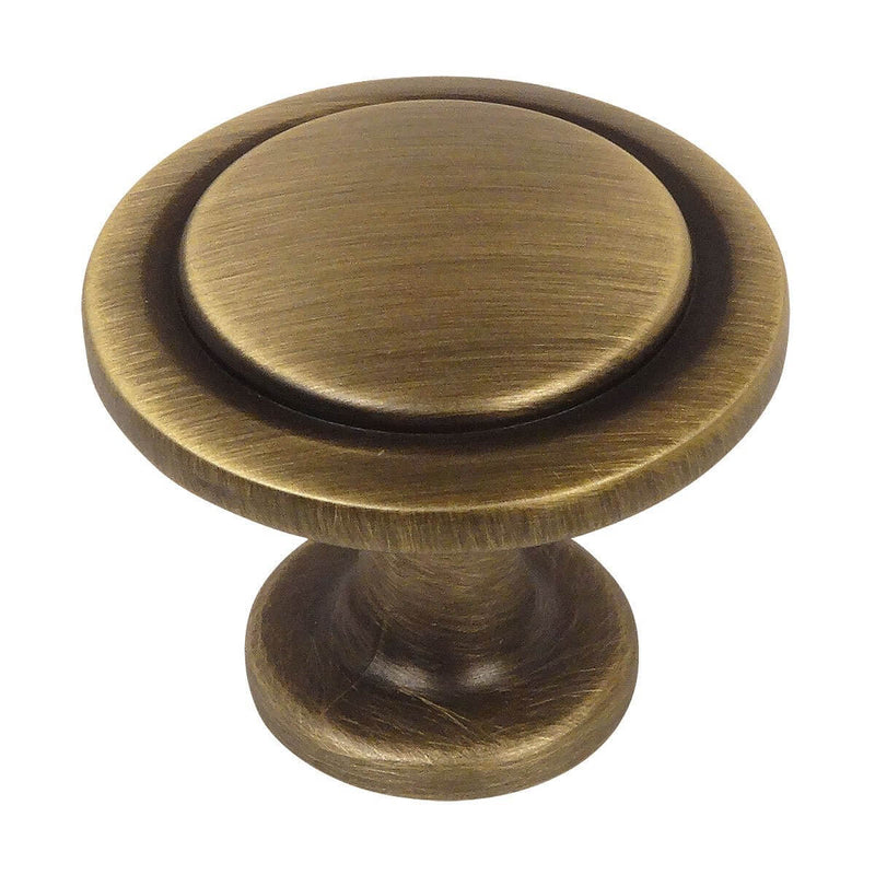 Round drawer knob in brushed antique brass finish with circle craving and one and a quarter inch diameter