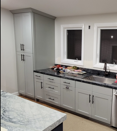 Kitchen remodel features gray cabients and the bronze Cosmas 305-128ORB pulls mounted on the drawers and pantry doors
