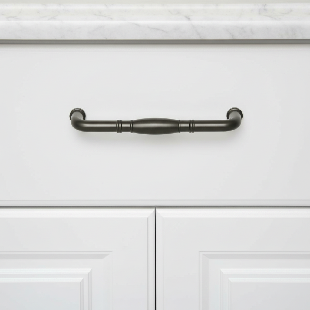 Graphite gray cabinet handle on a white cabinet with marble countertop