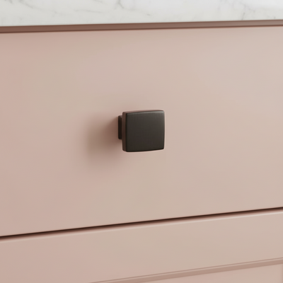 Close-up of a pink drawer with a oil rubbed bronze kitchen handle
