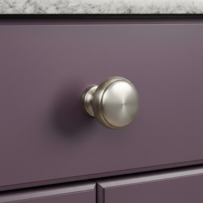 Purple drawer with a brushed nickel round knob on a marble countertop