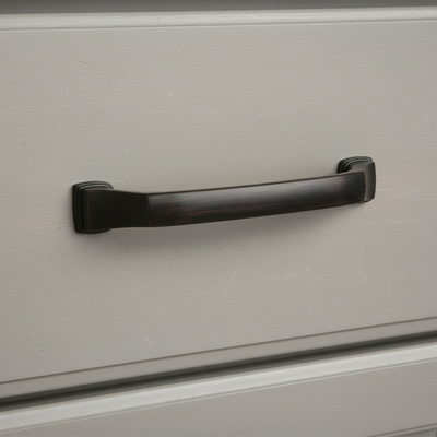 modern pull in oil rubbed bronze on a gray drawer front