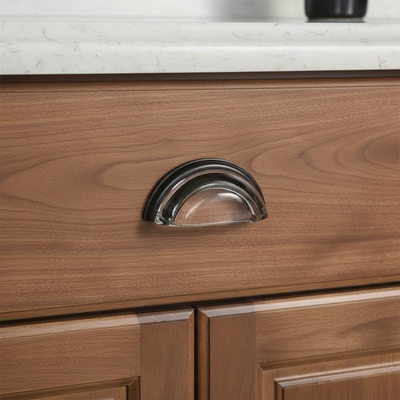 glass and oil rubbed bronze cabinet pull on a brown cabinet 
