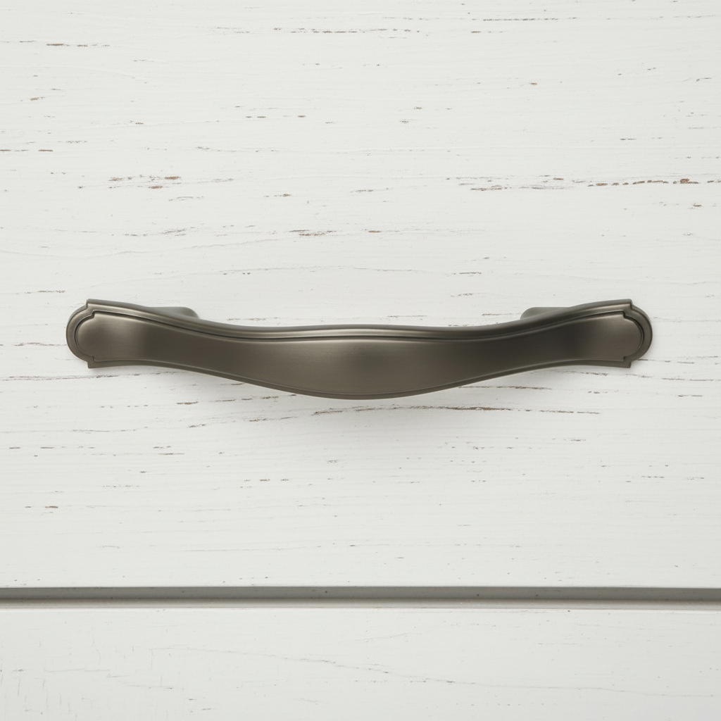 Graphite solid metal handle pull on a white wooden surface