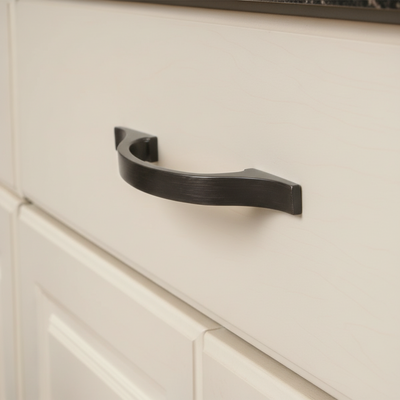 oil rubbed bronze cabinet handle on a beige cabinet