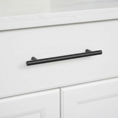 Oil rubbed bronze cabinet pull installed on a wood drawer 
