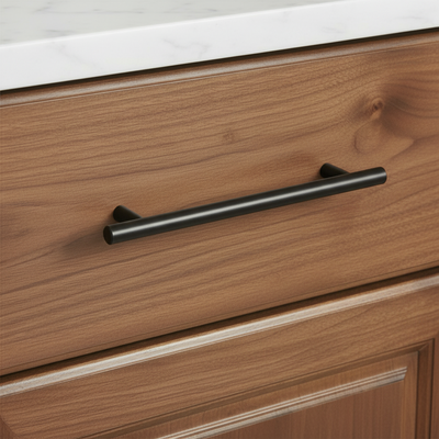 Wooden drawer with a oil rubbed bronze handle on a kitchen cabinet.