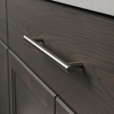 Close-up of a dark wood cabinet with a metallic handle
