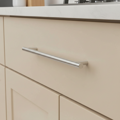 Close-up of a beige kitchen cabinet with a silver handle polished chrome