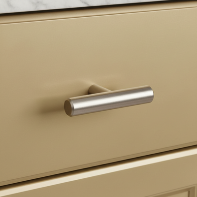 Beige drawer with a metallic handle on a kitchen cabinet.