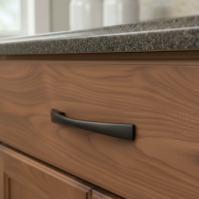 Wooden cabinet with a black handle in a kitchen setting
