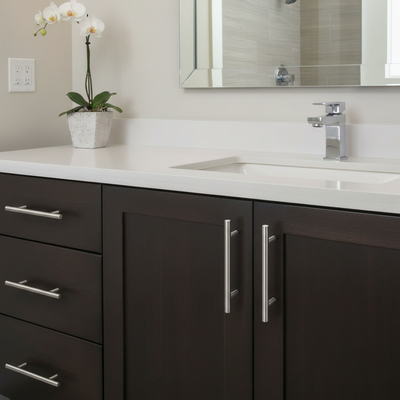 Bathroom vanity with dark cabinets, white countertop, and silver fixtures.