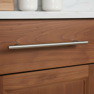 Wooden drawer with a satin nickel solid metal cabinet handle in a kitchen setting