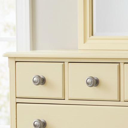 satin nickel cabinet knobs on a yellow  dresser 