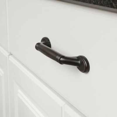 Black cabinet handle on a white cabinet door