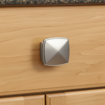square satin nickel cabinet knob on a wooden drawer