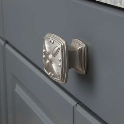 Decorative cabinet knob on a gray cabinet door