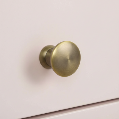 Brass door knob on a white door