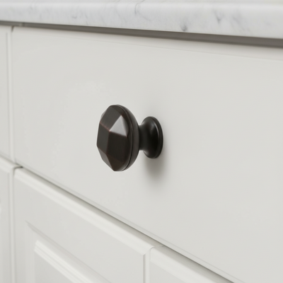 geometric cabinet knob on a warm cabinet drawer 
