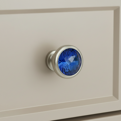 blue glass cabinet knob on a gray drawer 