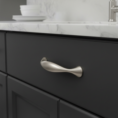 Black cabinet with a silver handle on a kitchen counter.