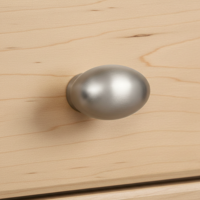satin nickel cabinet knob on a wooden drawer