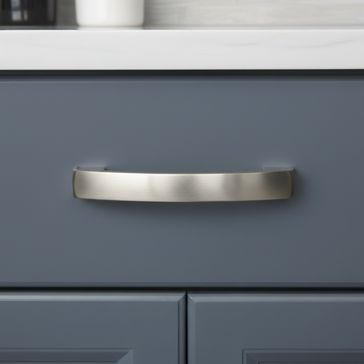silver satin nickel drawer pull on a blue drawer 