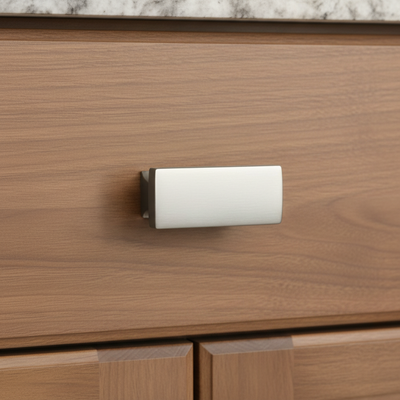 Wooden drawer with a metallic handle on a kitchen counter.