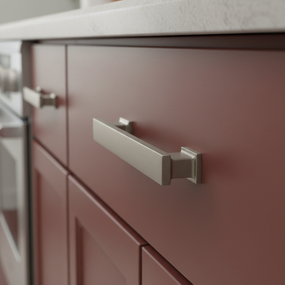 Close-up of a maroon cabinet with a silver handle in a kitchen setting