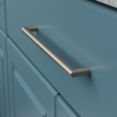 satin brushed nickel cabinet handle on a teal cabinet
