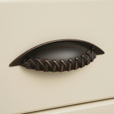 Decorative brown cabinet handle on a beige background