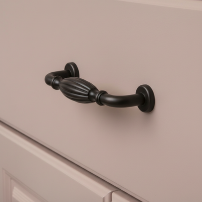 oil rubbed bronze cabinet handle on a beige cabinet