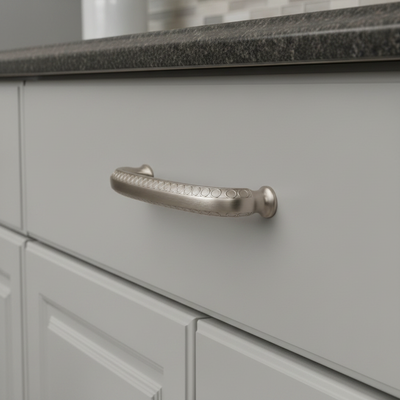 decorative satin nickel cabinet pull on a gray drawer 
