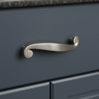 Silver handle on a blue cabinet with a granite countertop.