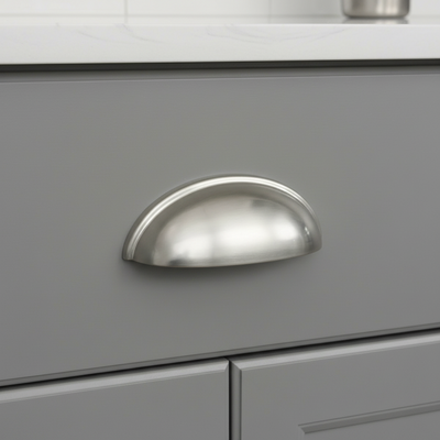 Brushed satin nickel cabinet cup pull handle.