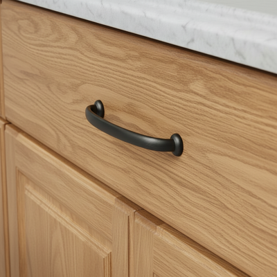 Wooden cabinet with a oil rubbed bronze  handle on a light wood finish