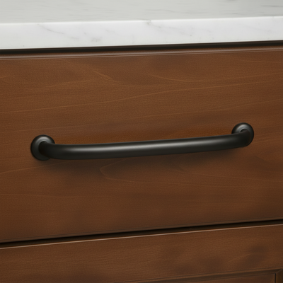 Wooden drawer with a black handle on a kitchen counter.