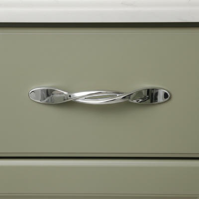 Silver cabinet handle with a wavy design on a white background