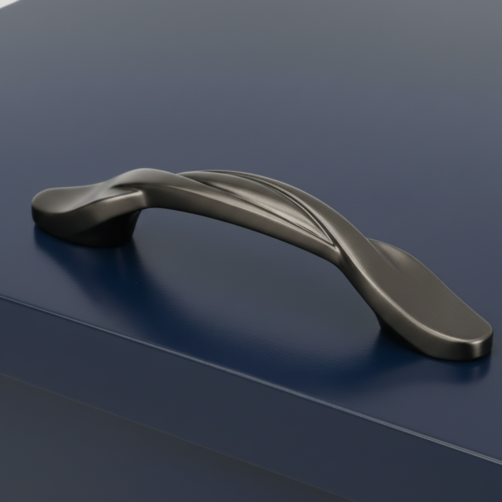 Graphite gray cabinet twist pull handle on a dark blue surface