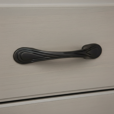 oil rubbed bronze  cabinet handle on a beige cabinet door