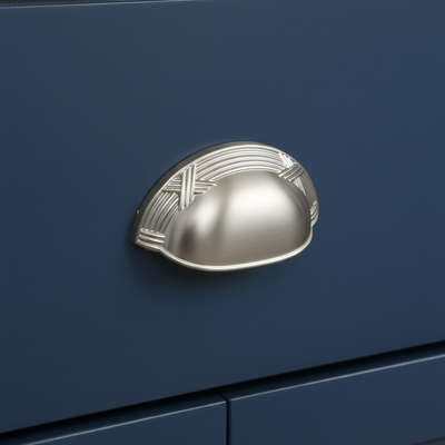 Decorative silver handle on a blue surface