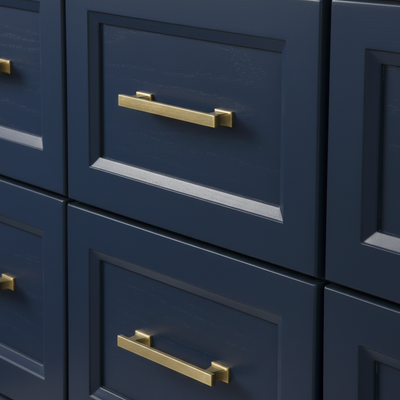 Blue drawers with gold handles on a matching cabinet