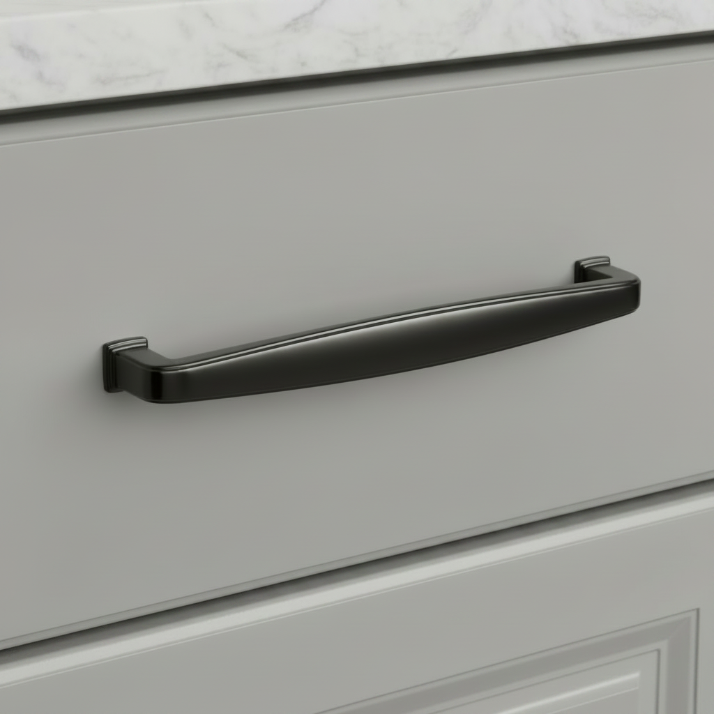 A black nickel drawer pull handle mounted on a light gray cabinet door, with part of a white marble countertop visible at the top.