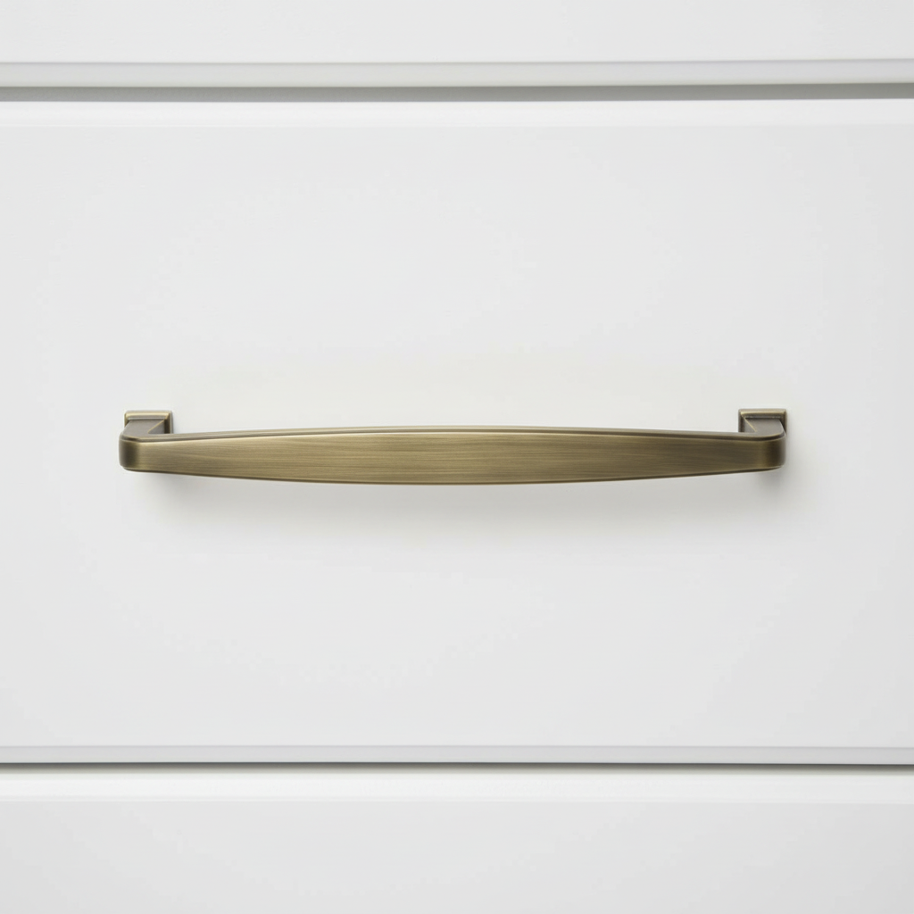 Brushed Antique Brass handle on a white cabinet door