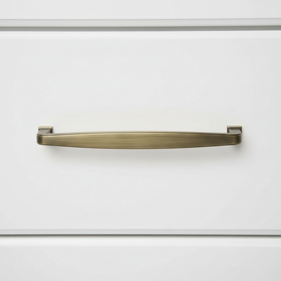 Brushed Antique Brass handle on a white cabinet door