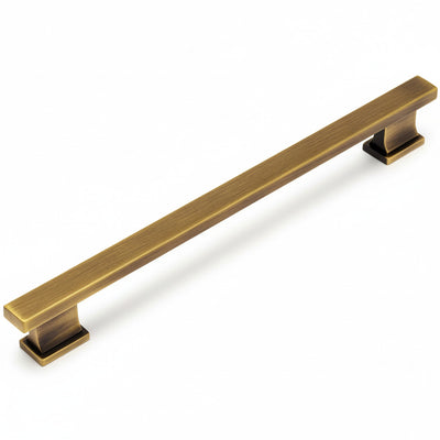 Brushed antique brass cabinet handle on a white background