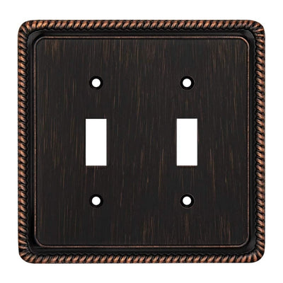 A square double-gang light switch plate with a dark bronze textured finish and a decorative twisted rope border, shown on a plain white background.